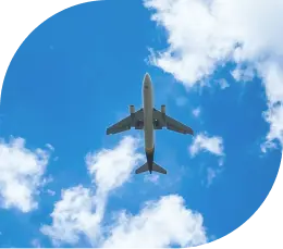 Airplane flying through blue sky with clouds Airplane flying through blue sky with clouds
