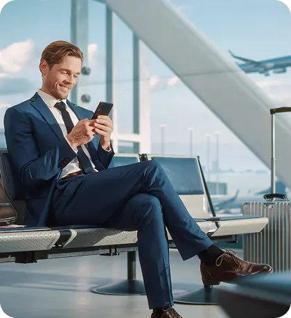 Professional businessman using phone in modern airport setting Professional businessman using phone in modern airport setting
