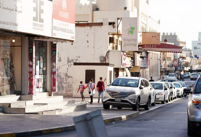 People are walking with masks in old bahraini town People are walking with masks in old bahraini town