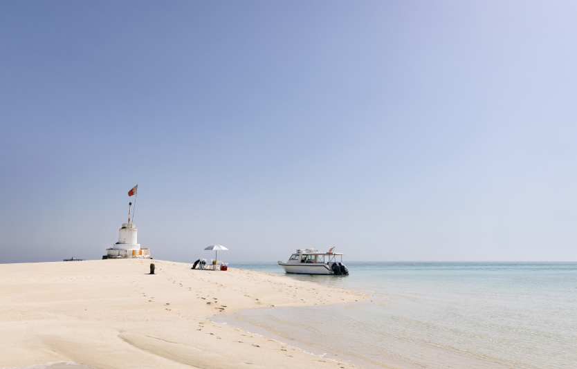  Tower with flag, yacht, umbrella and chairs placed on Jarada island 