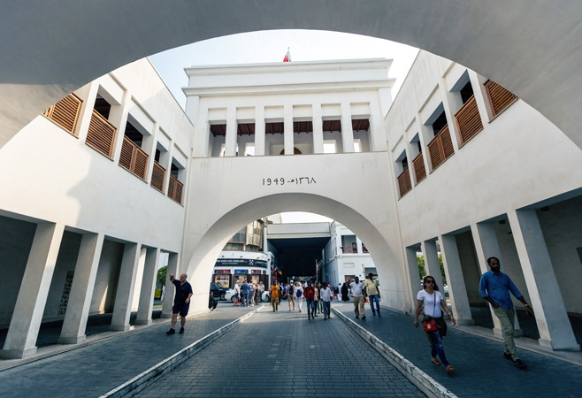 People walking through the market gate People walking through the market gate