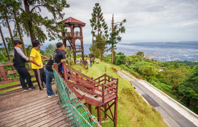 Tourists enjoy a view at Bukit Larut Tourists enjoy a view at Bukit Larut