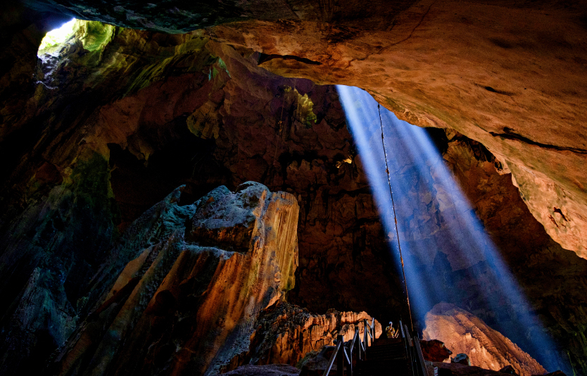 A tourist walks inside the Great Cave complex at Niah National Park in Sarawak