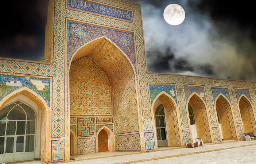 Poi kalyan complex illuminated by bright full moon at night in Bukhara, Uzbekistan